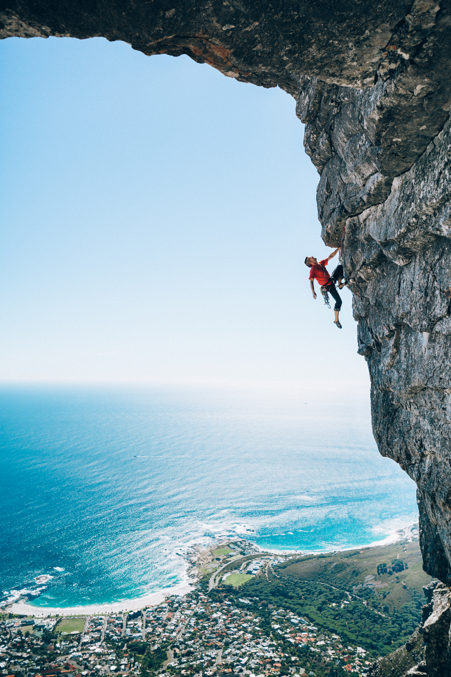 Person Scaling a Rock Cliff